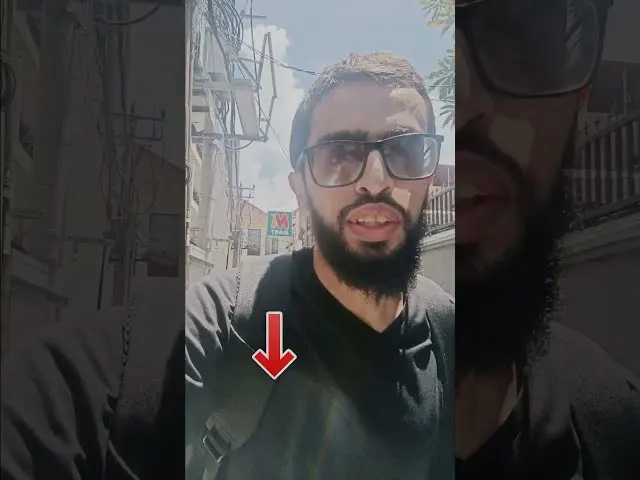 Man with beard wearing sunglasses and black shirt outdoors