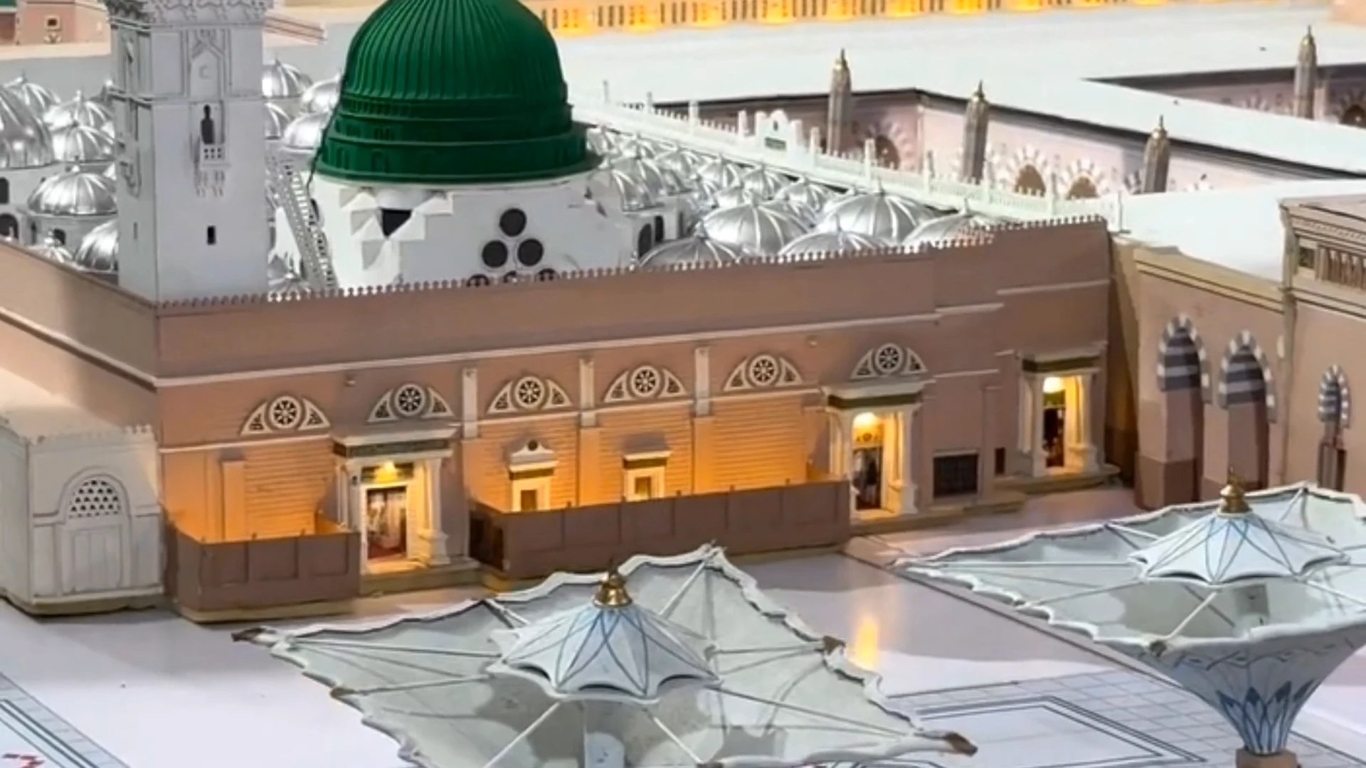 Beautifully lit scale model of Masjid Nabawi with the Green Dome at its centre