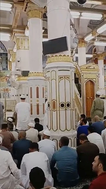 The golden grills of the Prophet's chamber at the boundary of Riyadh ul Jannah